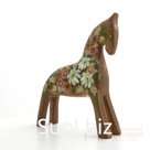 A dun horse with floral decoration