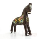 A bay horse with bouquets of wildflowers