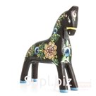 A black horse with a berry and flower arrangement